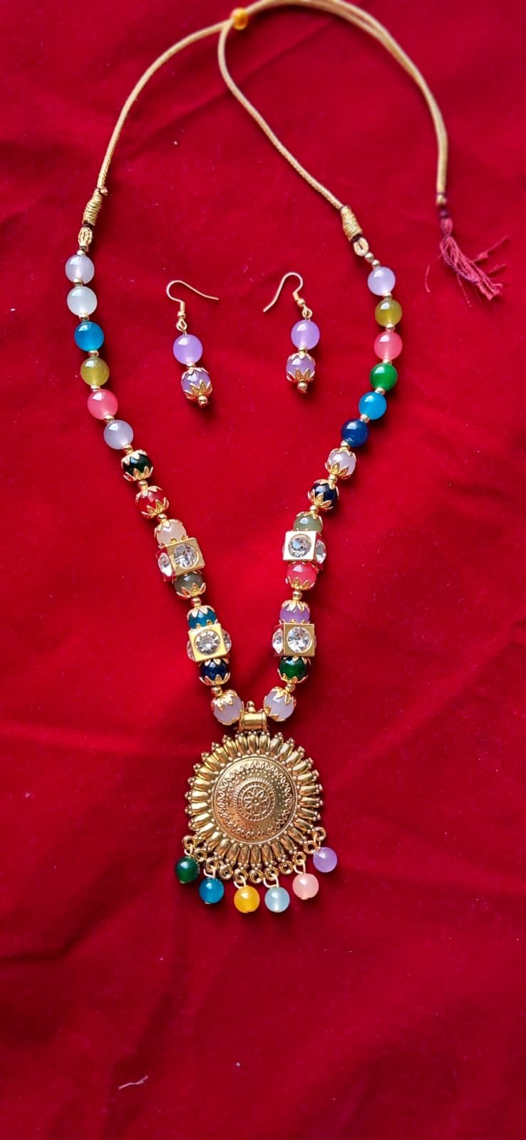 Elegant ethnic necklace set with multicolor beads and antique golden round pendant – includes matching earrings