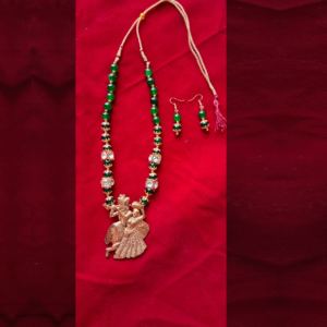 Handcrafted green beaded Radha Krishna necklace with matching earrings on red background – traditional Indian festive jewelry set