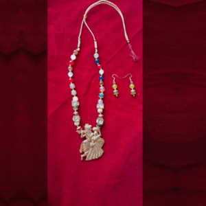Handcrafted multicolor Radha Krishna beaded necklace with matching earrings on red background