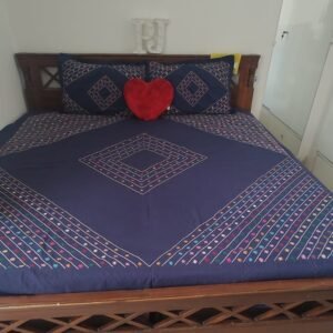 Handcrafted navy blue cotton bedsheet with colorful embroidery and matching pillow covers – 100% handmade home decor.